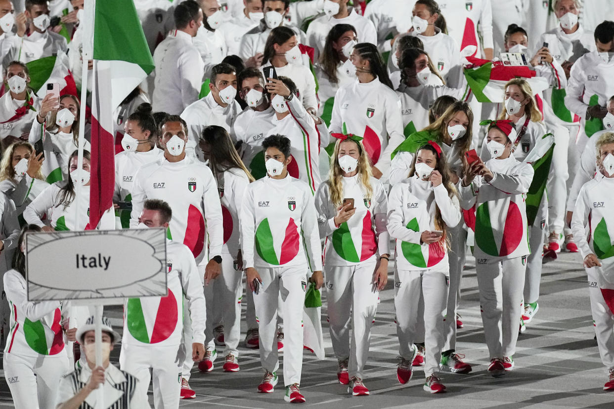 Athletes from Italy march during the opening ceremony in the Olympic Stadium at the 2020 Summer Olympics, Friday, July 23, 2021, in Tokyo, Japan. (AP Photo/David J. Phillip)