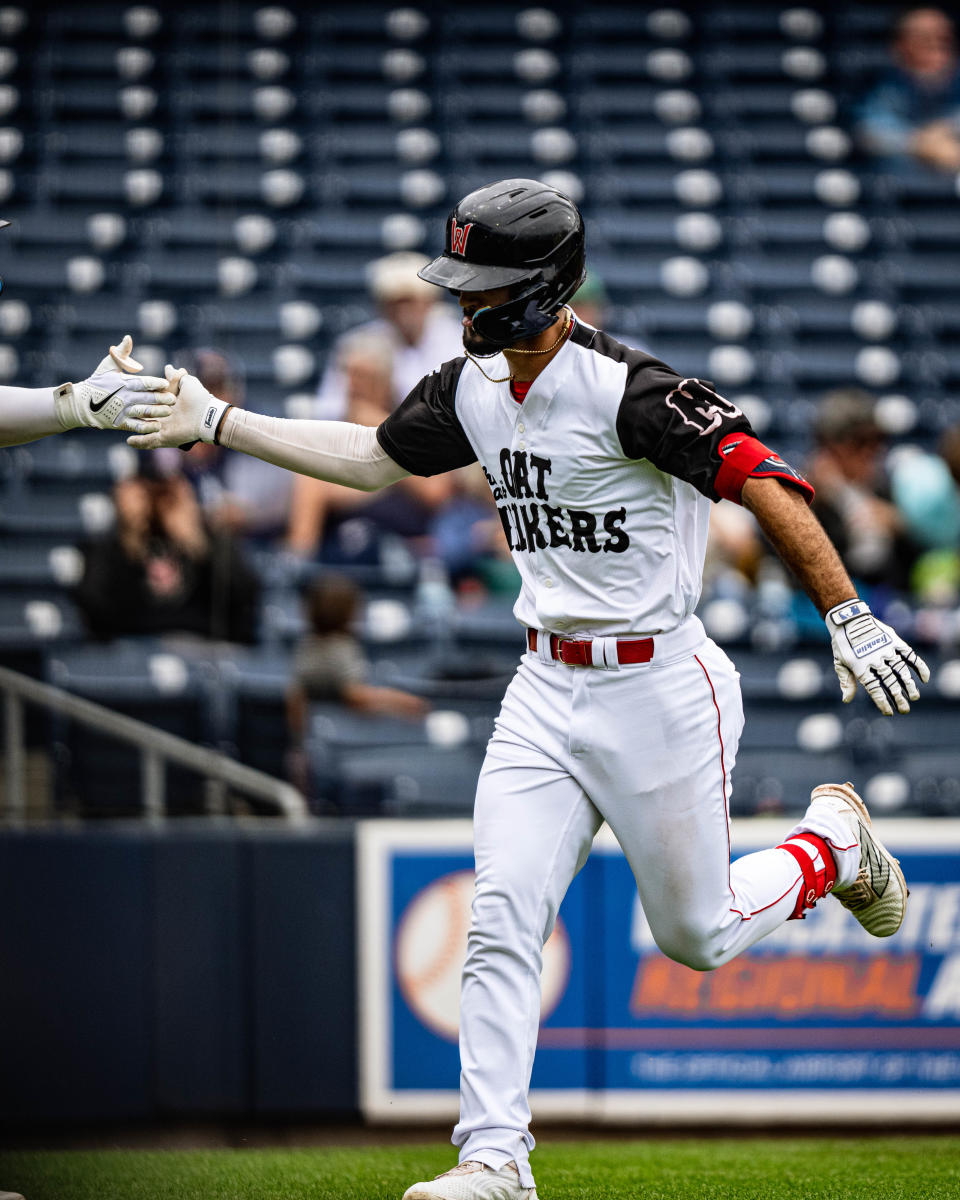 WooSox player Matthew Lugo gets a high five for hitting a home run in Worcester's 13-4 win over the Rochester Red Wings at Polar Park on Thursday.