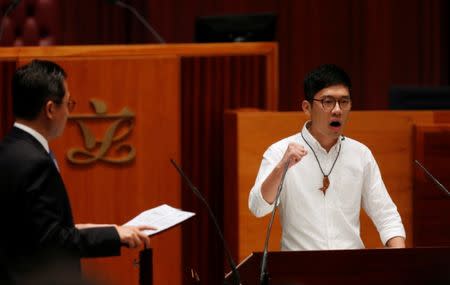 Newly-elected lawmaker Nathan Law chants slogans while taking oath at the Legislative Council in Hong Kong, China October 12, 2016. REUTERS/Bobby Yip