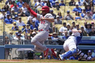 CORRECTS TO THE SECOND INNING NOT THIRD - St. Louis Cardinals' Willson Contreras, left, scores on a sacrifice fly hit by Dylan Carlson as Los Angeles Dodgers catcher Will Smith misses the throw during the second inning of a baseball game Sunday, April 30, 2023, in Los Angeles. (AP Photo/Mark J. Terrill)
