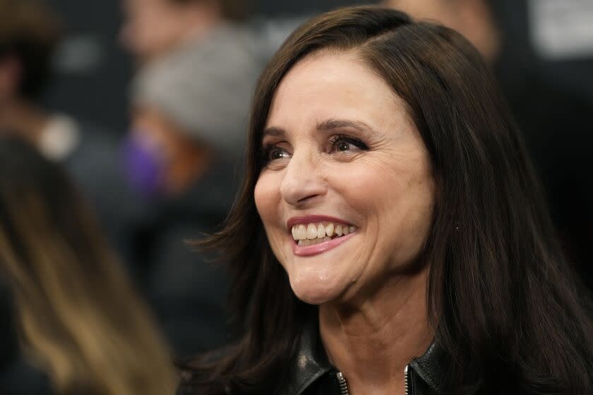 A woman with long brown hair smiling