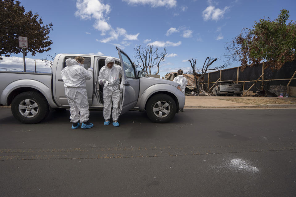 Michael Vierra, center, gets ready to see his home for the first time after the wildfire in August on Tuesday, Sept. 26, 2023, in Lahaina, Hawaii. (AP Photo/Mengshin Lin)