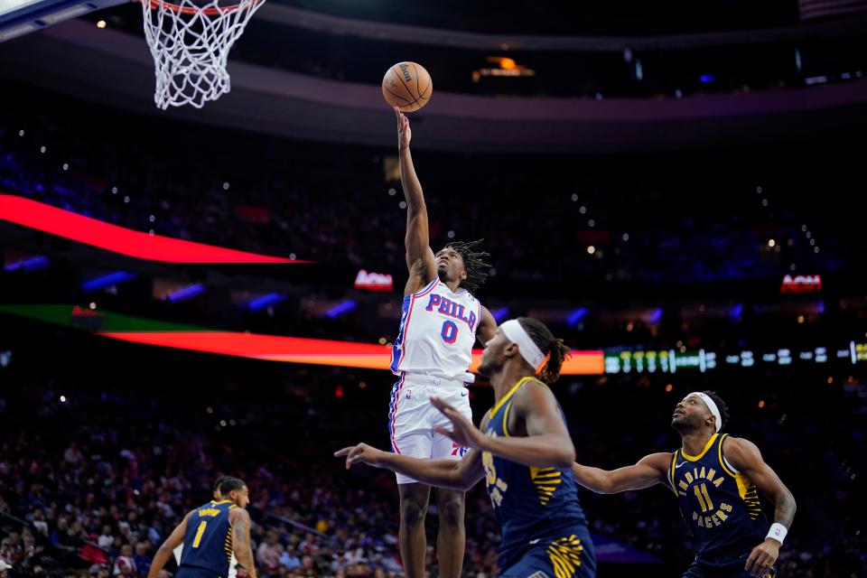 Philadelphia 76ers' Tyrese Maxey (0) goes up for a shot past Indiana Pacers' Myles Turner (33) and Bruce Brown (11) during the first half of an NBA basketball game, Sunday, Nov. 12, 2023, in Philadelphia. (AP Photo/Matt Slocum)