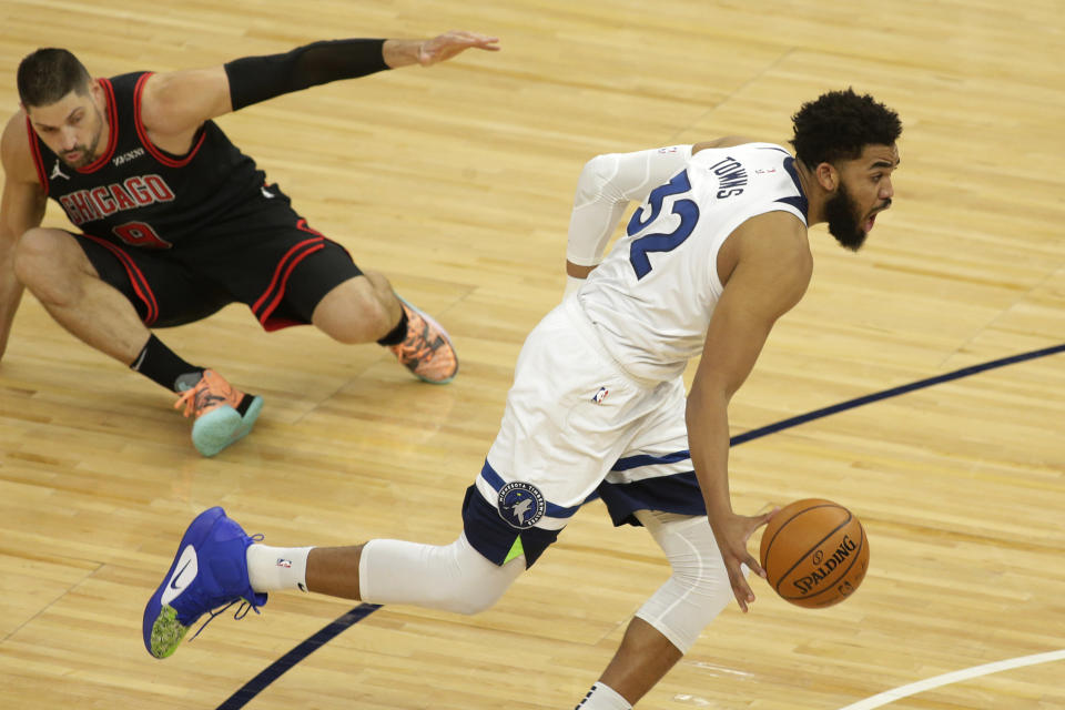 Minnesota Timberwolves center Karl-Anthony Towns (32) leaves Chicago Bulls center Nikola Vucevic (9) on the floor in the first quarter during an NBA basketball game, Sunday, April 11, 2021, in Minneapolis. (AP Photo/Andy Clayton-King)