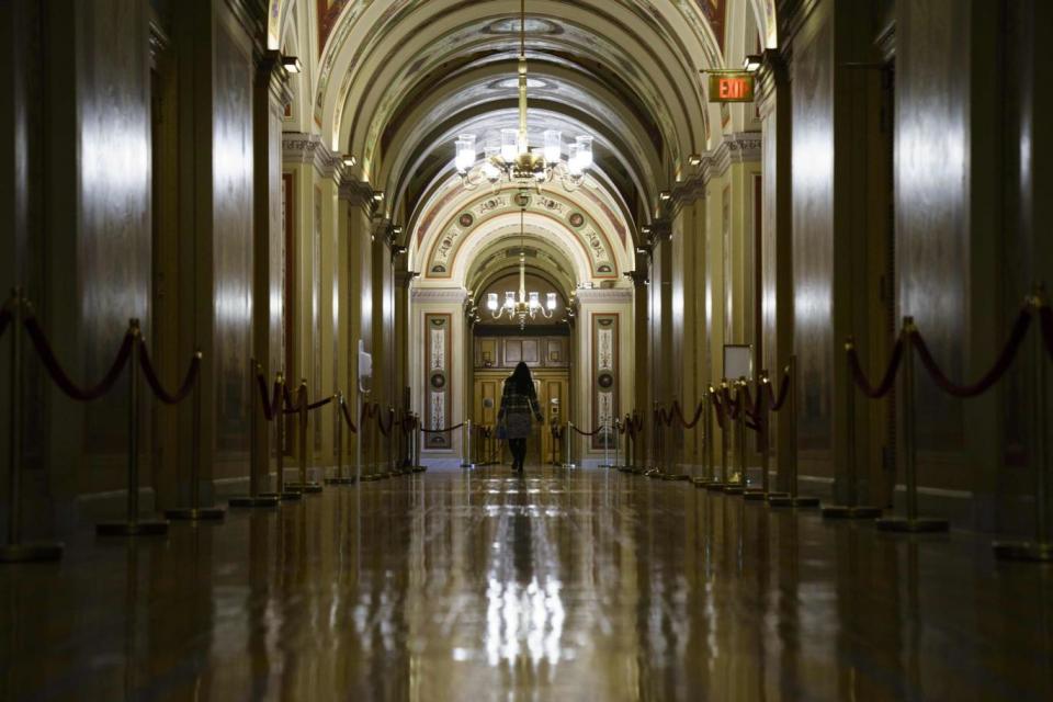 Shutdown: a woman walking through a quiet US Capitol before the Senate and House convene (AFP/Getty Images)