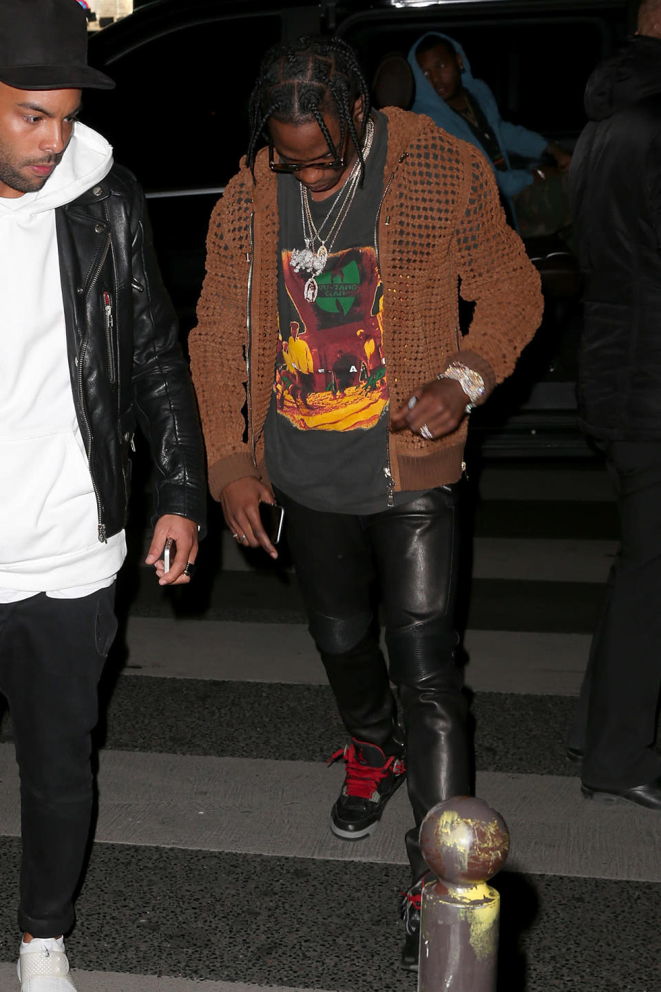 Travi$ Scott heading into the Balmain after party in a brown Balmain sweatshirt. 