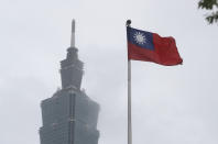 FILE - A Taiwan national flag flutters near the Taipei 101 building at the National Dr. Sun Yat-Sen Memorial Hall in Taipei, Taiwan, on May 7, 2023. Taiwan’s government is racing to counter China’s military, but many on the island say they don’t share the sense of threat. (AP Photo/Chiang Ying-ying, File)
