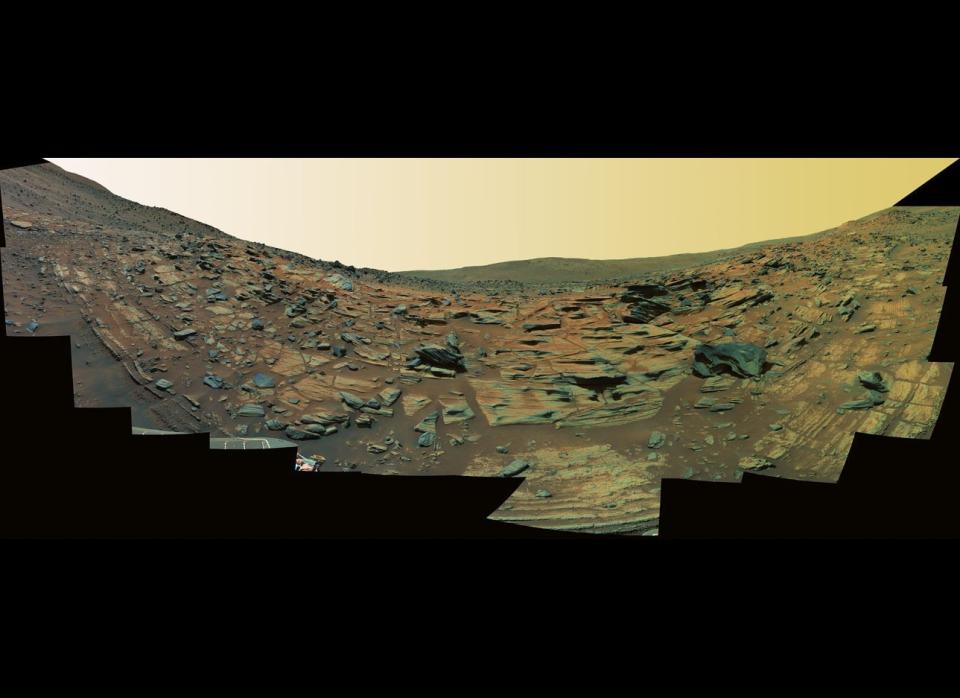 This Spirit Pancam false-color panorama from mission sols 748-751 (February 9-12, 2006) shows what could be finely-layered lithified ash fall deposits along the edge of an ancient, worn-down volcanic cinder cone called Home Plate.    <em>From "Postcards from Mars" by Jim Bell; Photo credit: NASA/JPL/Cornell University</em>  