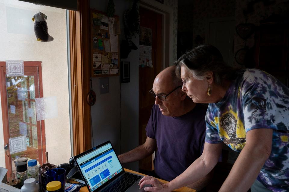 Sharon and Jeff Gustin log into the Project FeederWatch website to submit bird counts from their kitchen.