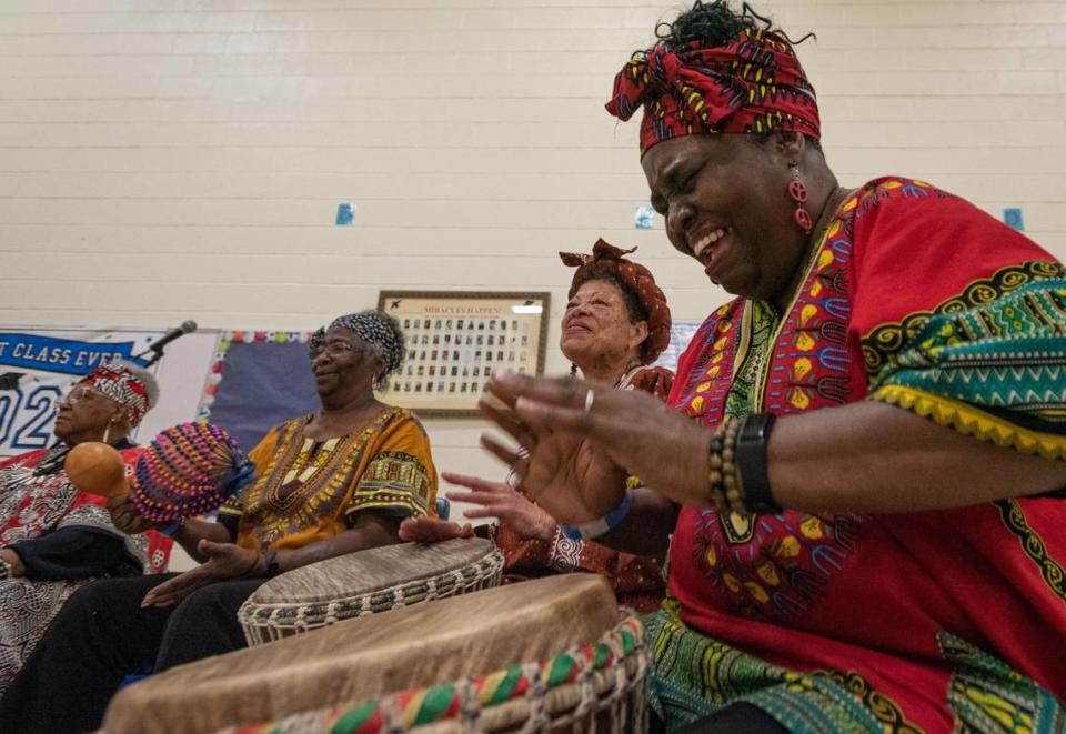 Barbarette Talley, right, of the Queen City Senior African Drummers, plays the djembe alongside several of her groupmates for a crowd of young children during the Juneteenth Festival of the Carolinas culture day camp Thursday, June 16, 2022, at Elizabeth Traditional Elementary School in Charlotte, N.C.