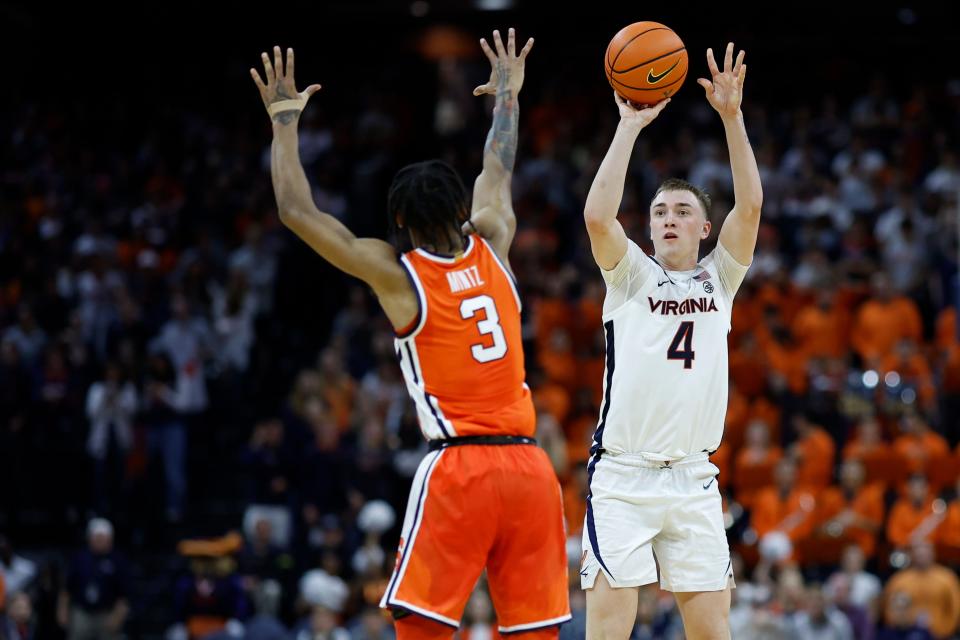 Virginia Cavaliers guard Andrew Rohde (4) shoots the ball over Syracuse Orange guard Judah Mintz (3) during the second half at John Paul Jones Arena on Dec. 2.