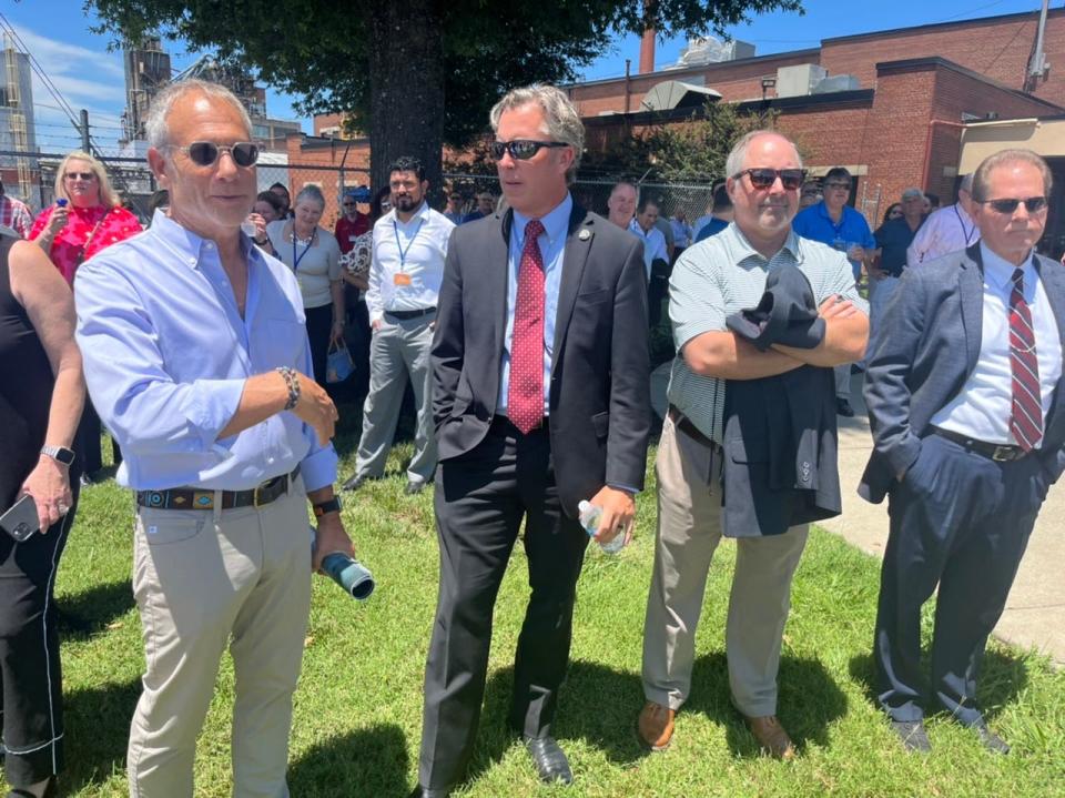 (Left) Bill Firestone, Connecticut-based representative of Capital Recovery Group LLC, and U.S. Rep. Andy Ogles, R-Tennessee, 5th Congressional District, converse ahead of the ribbon-cutting ceremony at the Mersen plant on Santa Fe Pike in Columbia, Tenn. as (right) state Sen. Joey Hensley, R-Hohenwald, looks on. on July 11, 2023.