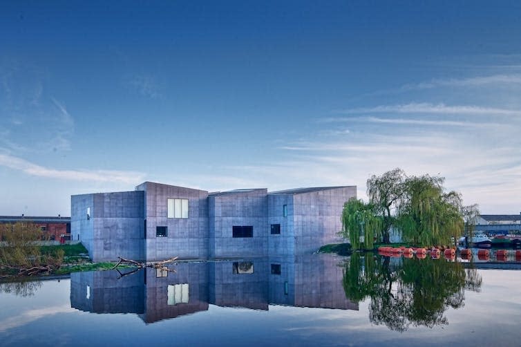 A building in front of a body of water.