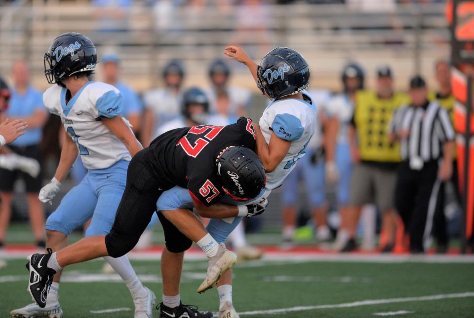 ROCORI's Mason Orth tackles the quarterback and applies pressure against Becker in the season opener on Friday, Aug. 26, 2022, at ROCORI High School.
