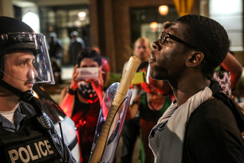 <p>A protester confront police during the second night of demonstrations after a not guilty verdict in the murder trial of former St. Louis police officer Jason Stockley, charged with the 2011 shooting of Anthony Lamar Smith, who was black, in St. Louis, Mo., Sept. 16, 2017. (Photo: Lawrence Bryant/Reuters) </p>