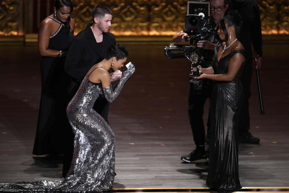 Nick Jonas, far left, and Adrienne Warren, far right, present the award for best performance by an actress in a leading role in a musical to Maleah Joi Moon for "Hell's Kitchen" during the 77th Tony Awards on Sunday, June 16, 2024, in New York. (Photo by Charles Sykes/Invision/AP)