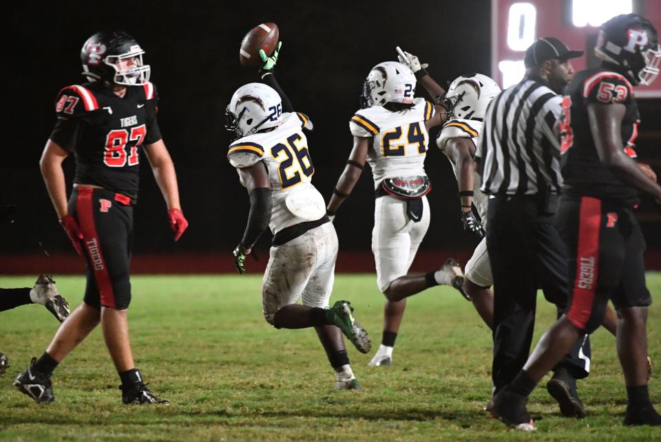 Lehigh's Marvel Pierre-Louis (#26) shows off the ball after recovering a Palmetto fumble. The Palmetto Tigers hosted the Lehigh Lightning in the FHSAA class 4S playoffs Friday night, Nov. 11, 2022. 