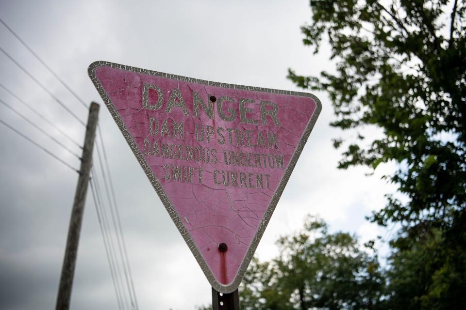 At the Cynthiana, Kentucky, boat ramp, a sign warns the community about the dangers of an upstream dam. Kenny Ratliff, now 54 years old, used this boat ramp to go kayaking with his father and brother on the day of their fatal accident in 1997.