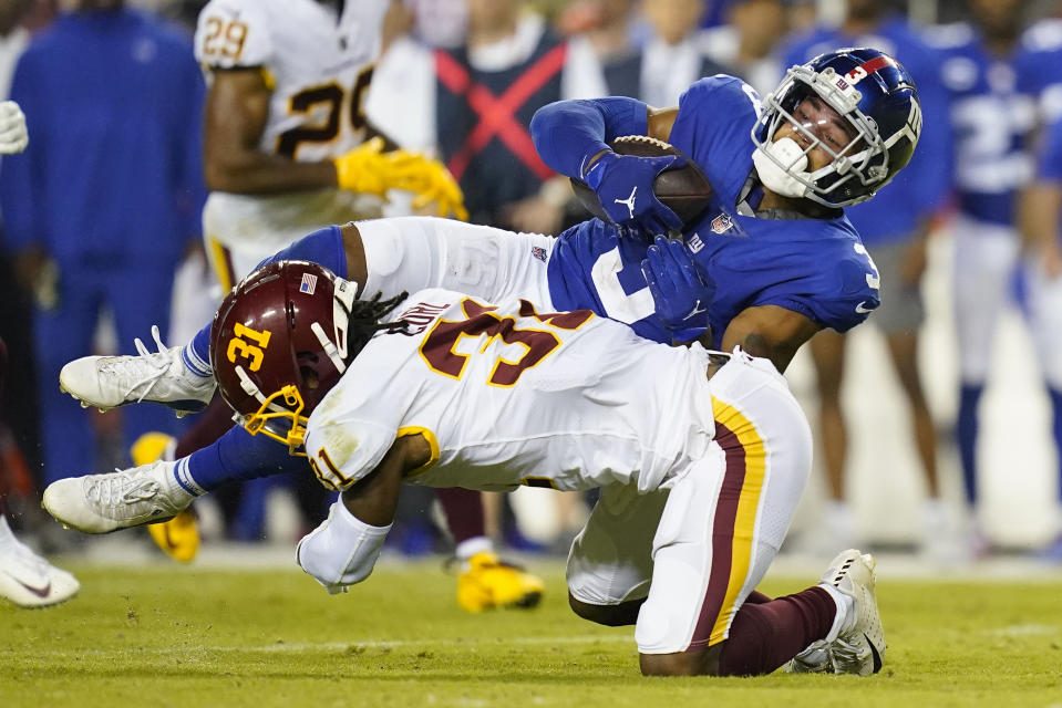 New York Giants wide receiver Sterling Shepard (3) is tackled by Washington Football Team safety Kamren Curl (31) during the second half of an NFL football game, Thursday, Sept. 16, 2021, in Landover, Md. (AP Photo/Patrick Semansky)