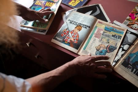 Michael Netzer, an American comics artist formerly named Mike Nasser, shows a comic book page he worked on, at his attic studio in his home in the Jewish settlement of Ofra in the Israeli-occupied West Bank