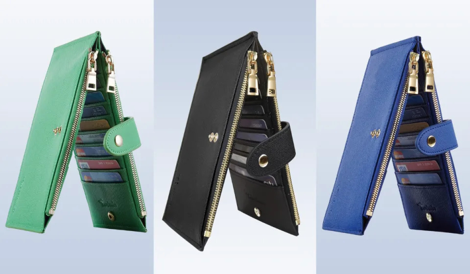 three travel wallets in green, black and blue