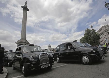 Taxi drivers block the road in Trafalgar Square in central London June 11, 2014. REUTERS/Luke MacGregor