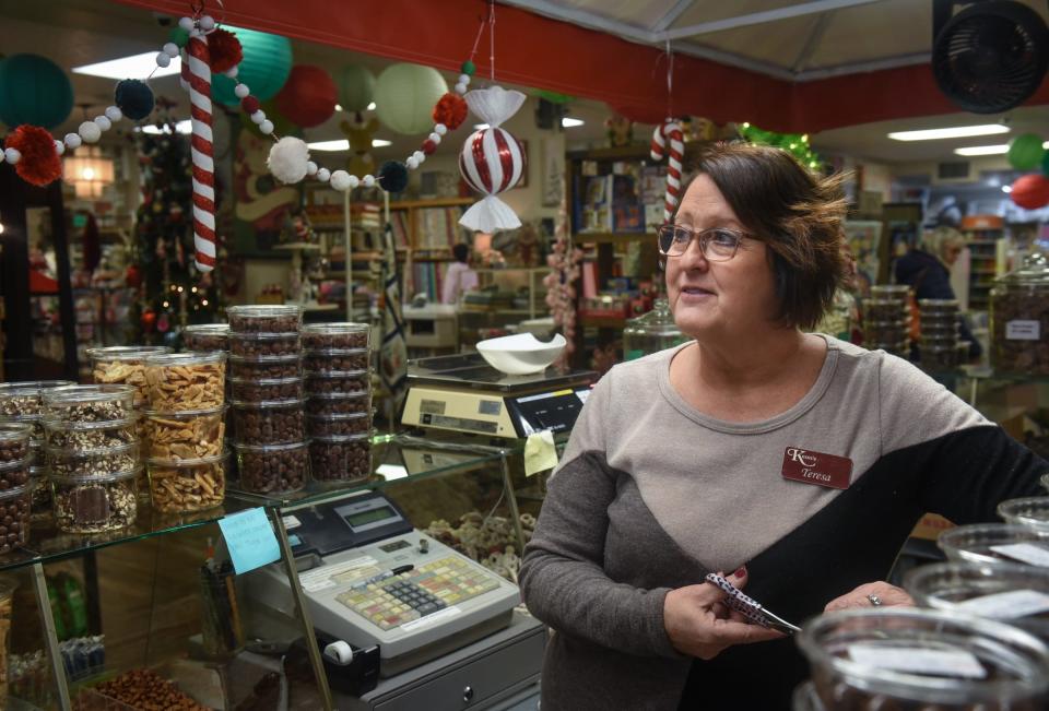 "Business has been good. We wouldn't be here without the support of our community," Teresa Wren of Kean's Store Co. in Mason says Wednesday, Dec. 7, 2022, as she restocks the store's iconic candy counter. Kean's Store Co. has been open for 94 years. Wren has been at the helm for 30.