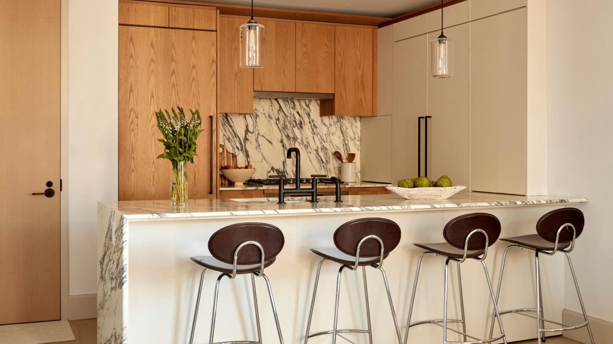  Kitchen in light wood and marble backsplash. 