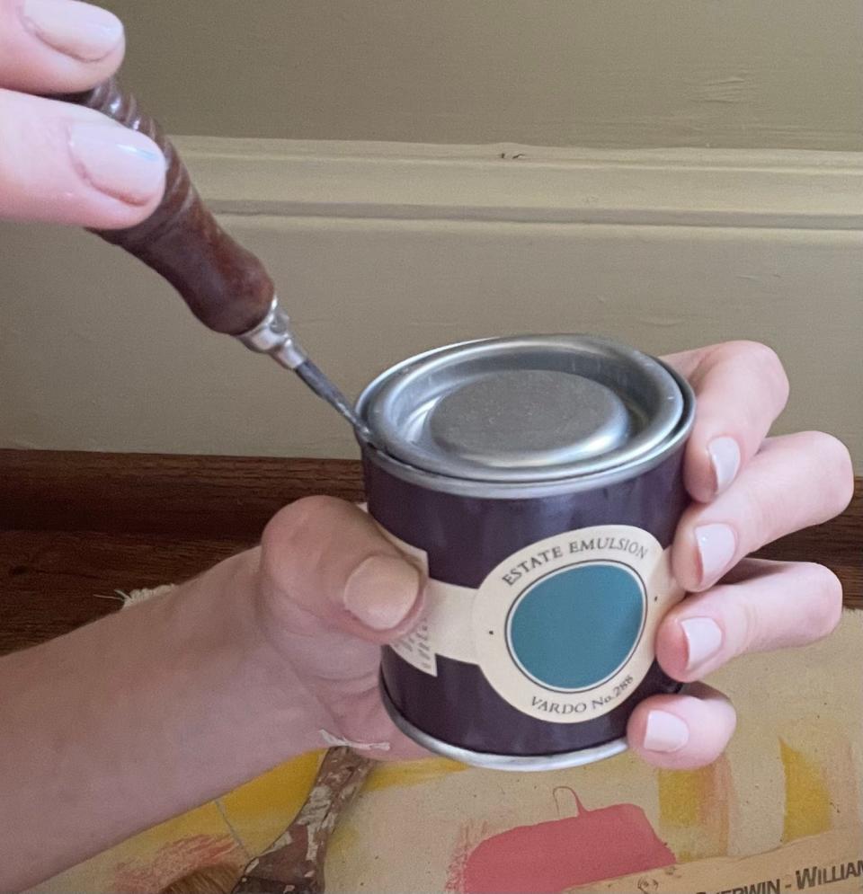 open a paint can with a flathead screwdriver