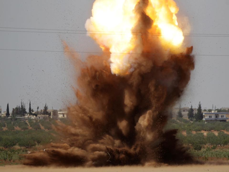 Smoke rises after civil defence members safely detonate cluster bombs inside a field in al-Tmanah town in southern Idlib countryside, Syria: Reuters