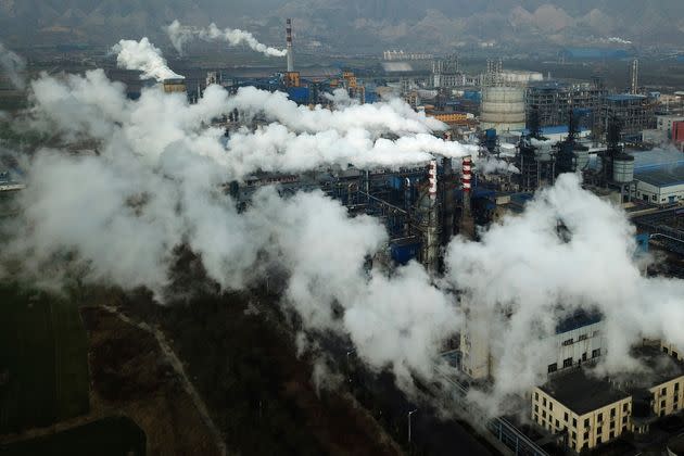 Smoke and steam rise from a coal processing plant that produces carbon black, an ingredient in steel manufacturing, in Hejin, China.