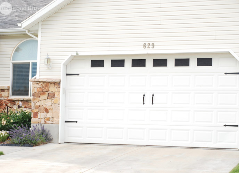 <body> <p>All it takes is black paint and a few pieces of hardware to bring carriage-style charm to a generic <a rel="nofollow noopener" href=" http://www.bobvila.com/slideshow/buyer-s-guide-7-best-garage-door-openers-49420?#.V40pZZMrKRs?bv=yahoo" target="_blank" data-ylk="slk:garage door;elm:context_link;itc:0;sec:content-canvas" class="link ">garage door</a>. For about $20, you can purchase a set that includes metal handles and hinges as well as magnets to attach them. Once you've installed the hardware, tape off a row of rectangular panels toward the top of the door, then prime and paint with black exterior paint to create the illusion of windows.</p> <p><strong>Related: <a rel="nofollow noopener" href=" http://www.bobvila.com/slideshow/12-ideas-to-steal-from-the-most-organized-garages-50062?#.V40pVJMrKRs?bv=yahoo" target="_blank" data-ylk="slk:12 Ideas to Steal from the Most Organized Garages;elm:context_link;itc:0;sec:content-canvas" class="link ">12 Ideas to Steal from the Most Organized Garages</a> </strong> </p> </body>