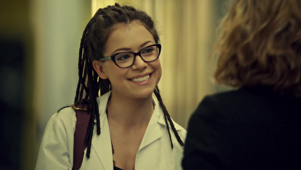Orphan Black's Cosima wears glasses and smiles.