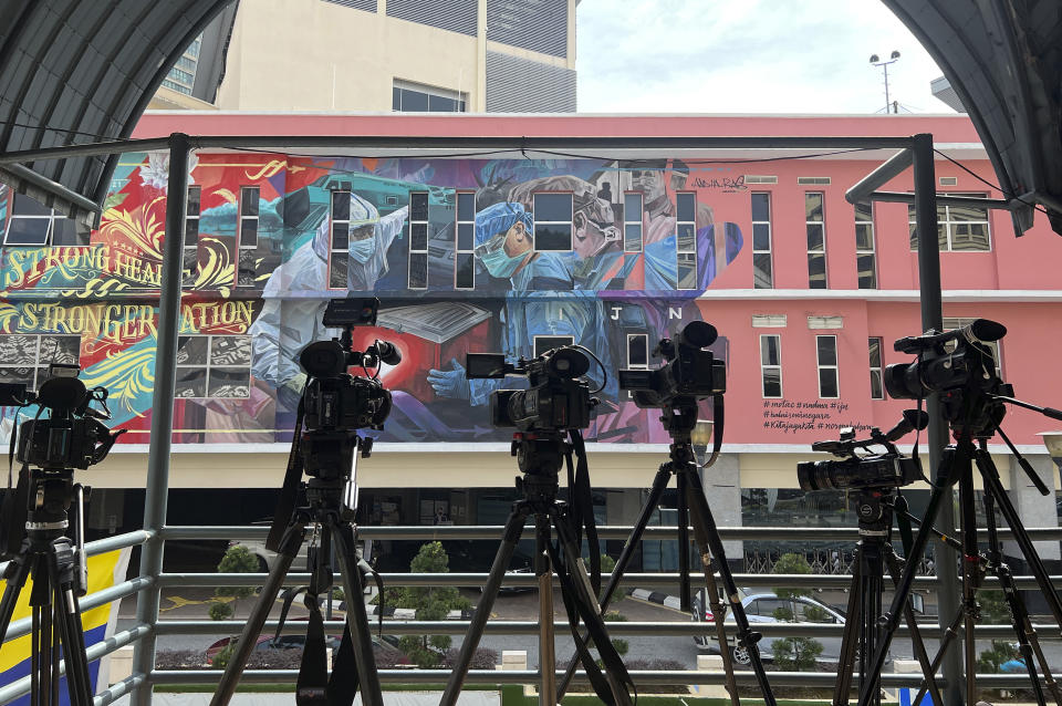 Media gather outside National Heart Center as former Prime Minister Mahathir Mohamad was said to have been brought to the Cardiac Care unit in Kuala Lumpur, Malaysia, Saturday, Jan 22, 2022. (AP Photo/Vincent Thian)