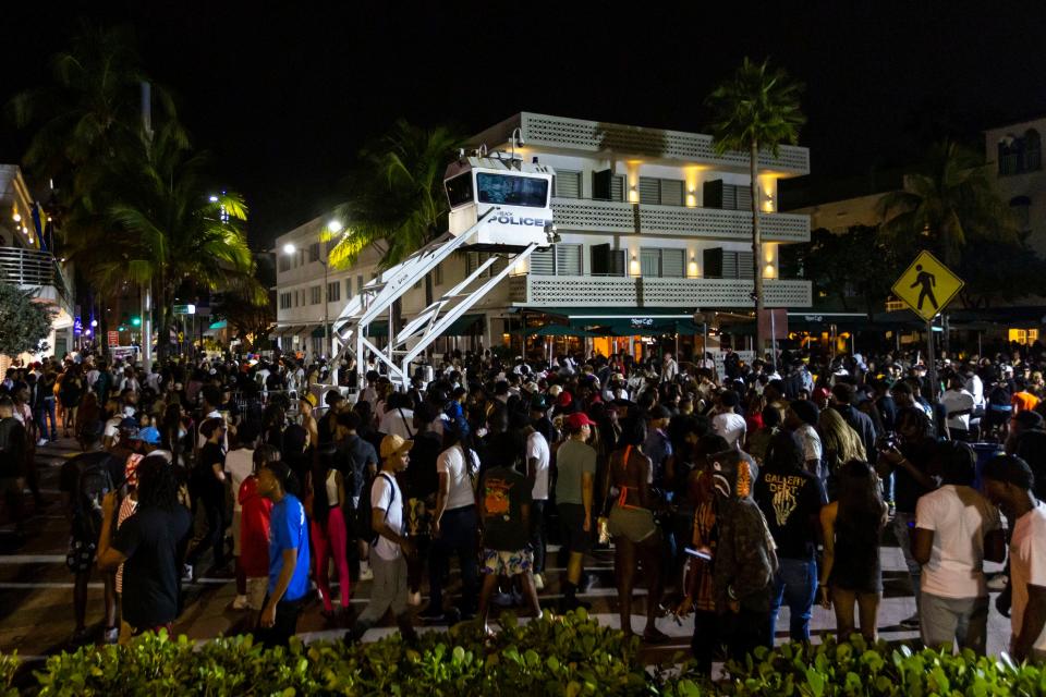 Crowds gather at Ocean Drive and 8th during spring break on Saturday, March 18, 2023, in Miami Beach, Fla. Miami Beach officials imposed a curfew March 19, after two fatal shootings and rowdy, chaotic crowds that police have had difficulty controlling. An execution-style shooting with a stolen gun from Tallahassee spurred the city to imposed a curfew for spring break and in 2024.