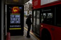 A UK government warning is seen at a bus stop in London