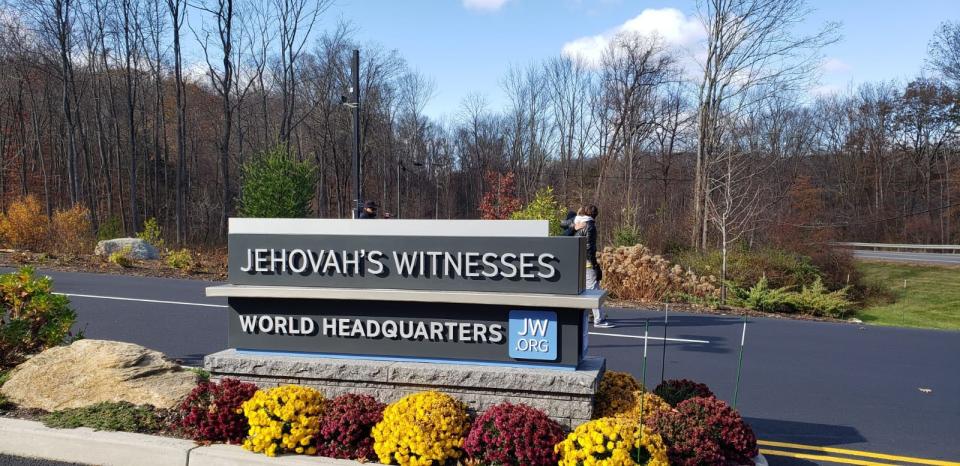 A sign marks the entrance of the Jehovah's Witness world headquarters in Tuxedo Park, New York.