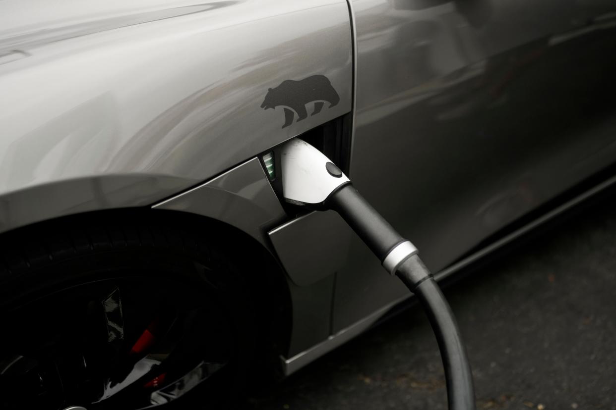 A Combined Charging System connector is plugged into an electric vehicle at a charging station, June 9, 2023, in Anaheim, California. On Thursday, Dec. 21, Maine environmental regulators are set to decide whether the state should join others that have adopted California-style regulations that drastically limit the sale of new gas-powered vehicles.