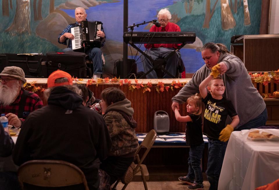 Eero Taisto, 83, of Three Lakes, plays accordion as his friend Glenn Adams, 87, of Republic, plays keyboards, while Chole Hill, 3, and her brother Dougie Hill, 6, dance with their grandmother Twilia Stager, 46, during the annual Hunter's Stew on Saturday, Nov. 18, 2023 in Herman. Stager, who is from Wisconsin, has a house in Herman and was visiting with her grandkids.
