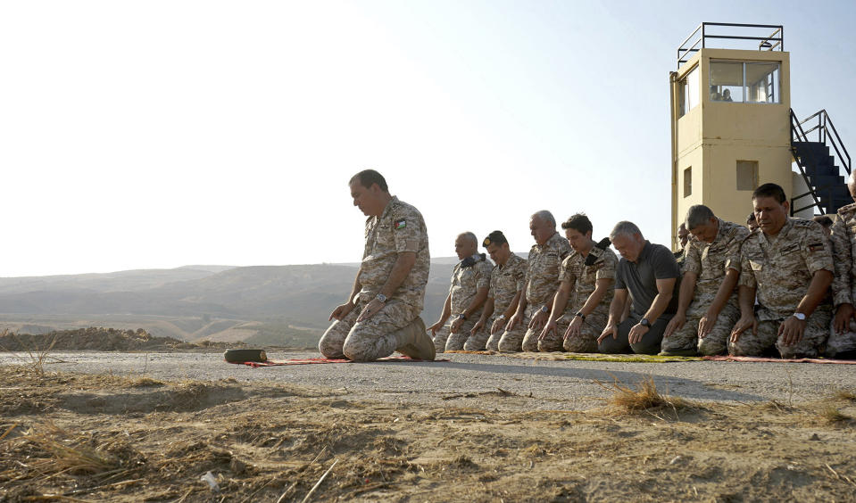 Jordan’s King Abdullah II, third right, prays during a tour of the Baqura enclave formerly leased by Israel, with Crown Prince Hussein, fourth right, and military officers, Monday, Nov. 11, 2019. Jordan’s decision not to renew the leases on the Baqura and Ghamr enclaves, known in Hebrew as Naharayim and Tzofar, were a fresh blow to Israel and Jordan’s rocky relations 25 years after the two countries signed a peace deal. (Yousef Allan/Jordanian Royal Court via AP)