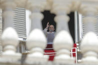 Pope Francis delivers his blessing as he recites the Angelus noon prayer from the window of his studio overlooking St.Peter's Square, at the Vatican, Sunday, June 7, 2020. Pope Francis is cautioning people in countries emerging from lockdown to keep following authorities’ rules for COVID-19 contagion containment. Says Francis: “Be careful, don’t cry victory, don’t cry victory too soon.” (AP Photo/Andrew Medichini)