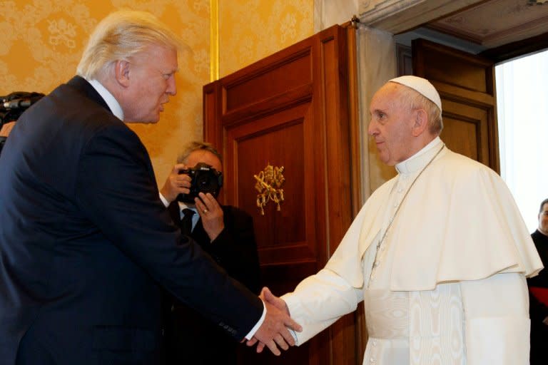 Pope Francis shakes hands with US President Donald Trump during a private audience at the Vatican