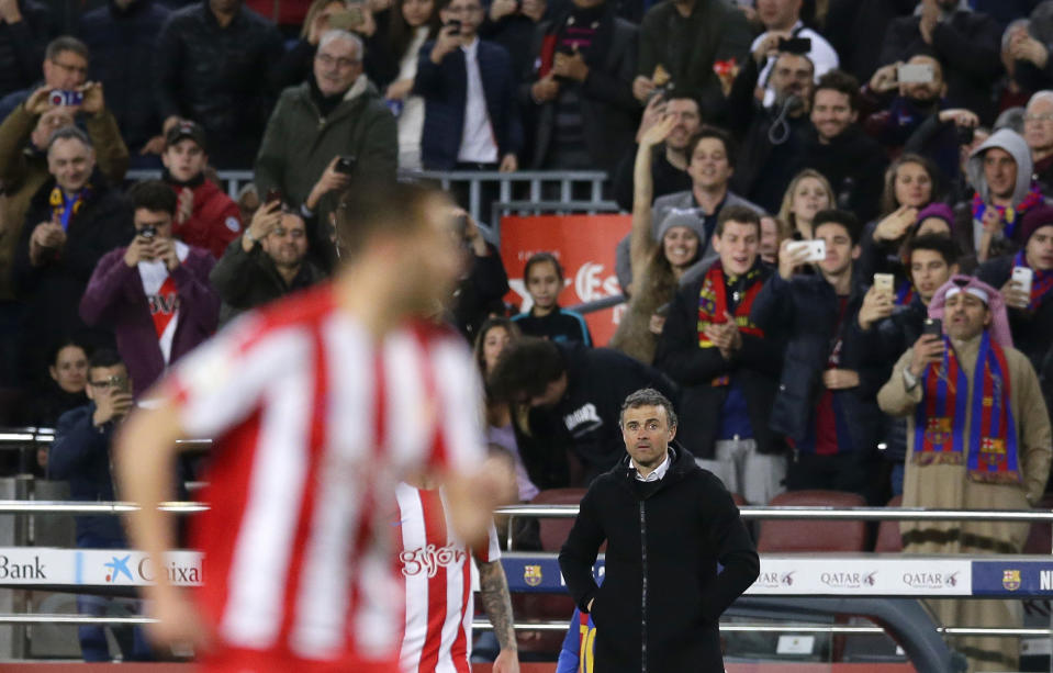 FC Barcelona's coach Luis Enrique, center right, stands during the Spanish La Liga soccer match between FC Barcelona and Sporting Gijon at the Camp Nou stadium in Barcelona, Spain, Wednesday, March 1, 2017. Luis Enrique says he will not stay as Barcelona coach after this season. The surprise announcement was made following the team’s 6-1 win over Sporting Gijon in the Spanish league on Wednesday. (AP Photo/Manu Fernandez)