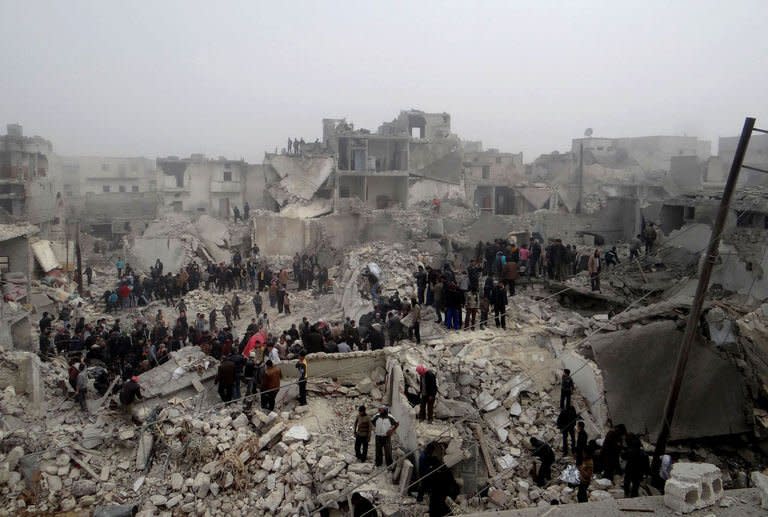 A picture released by Syria's opposition-run Aleppo Media Centre shows Syrians inspecting destruction following an apparent surface-to-surface missile strike on the city of Aleppo on February 19, 2013. Insurgents fired mortar rounds at one of President Bashar al-Assad's palaces in the Syrian capital on Tuesday, as the death toll mounted from a devastating missile strike on second city Aleppo