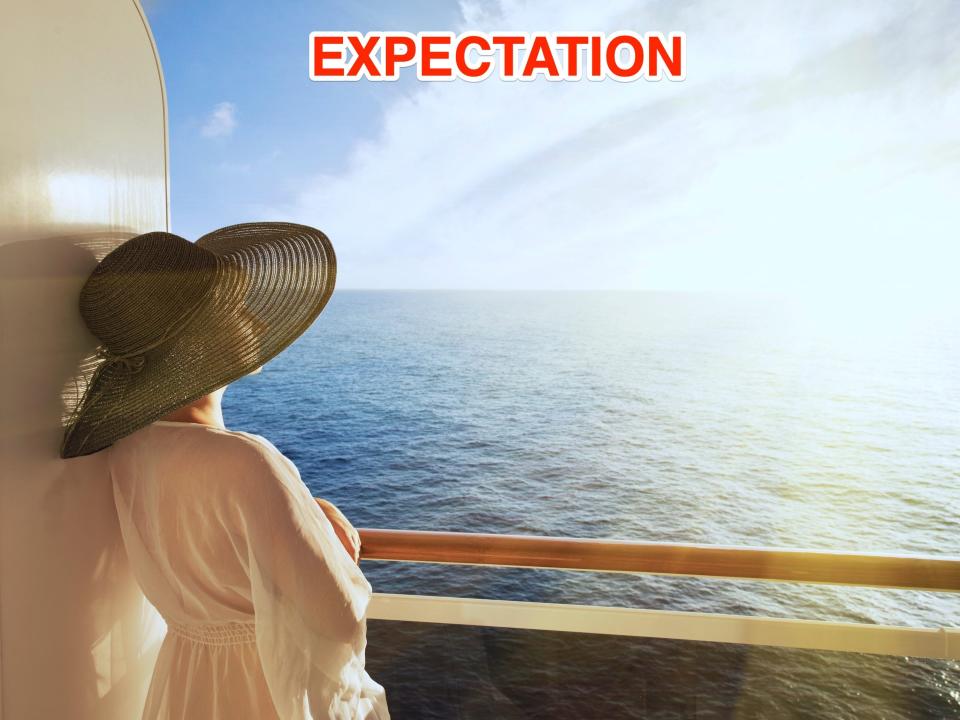 A woman in a hat looks out over water from a boat