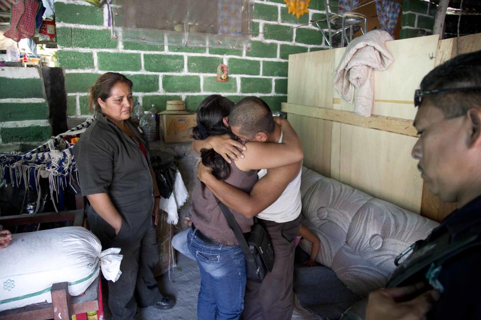 In this Feb. 5, 2014, photo, Juan Corso embraces a relative at his home in Yautepec, Mexico. Corso, showed up after missing eight days and said he was kidnapped before making a deposit at a bank. Yautepec sits in the center a relatively prosperous and heavily populated stretch of suburbanizing countryside that stretches east from Cuernavaca, the capital of Morelos, the second-smallest of Mexico’s 31 states and among the top five in kidnappings per capita, according to federal statistics. (AP Photo/Eduardo Verdugo)
