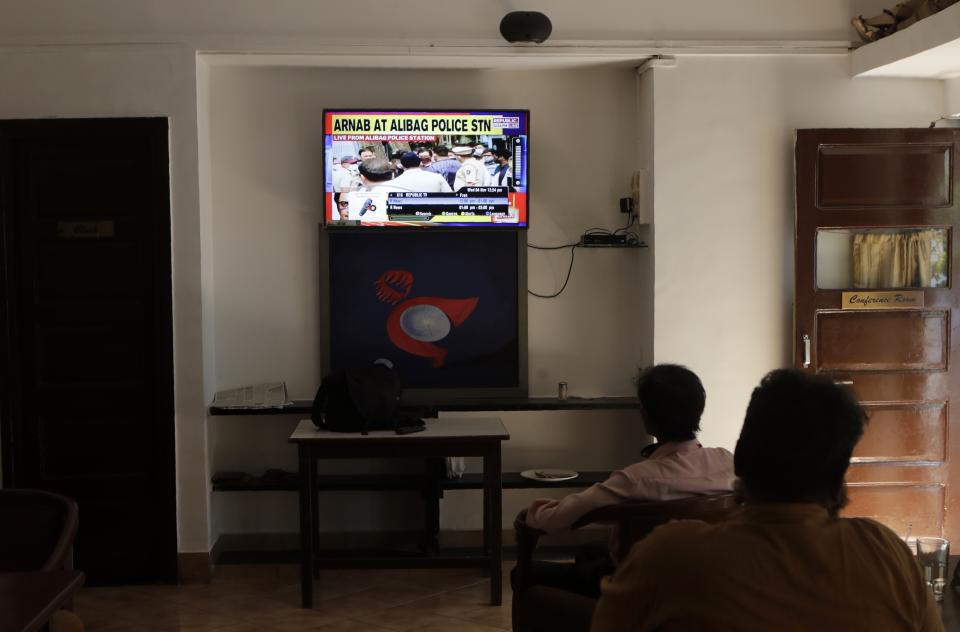 Journalists watch on television the news of the arrest of television news anchor Arnab Goswami at the Mumbai Press Club in Mumbai, India, Wednesday, Nov. 4, 2020. Indian police on Wednesday said they arrested the Republic TV founder and charged him with abetment to suicide in connection with the 2018 deaths of an interior designer and the designer's mother. (AP Photo/Rajanish Kakade)