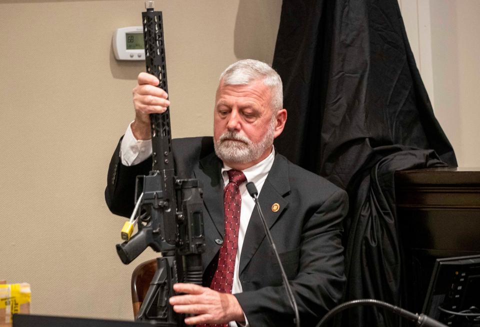 Jan 31, 2023; Walterboro, SC, USA; SLED agent Jeff Croft holding a .300 blackout rifle while being cross-examined by defense attorney Jim Griffin in the double murder trial of Alex Murdaugh at the Colleton County Courthouse in Walterboro, Tuesday, Jan. 31, 2023. Mandatory Credit: Andrew J. Whitaker/Pool via USA TODAY NETWORK