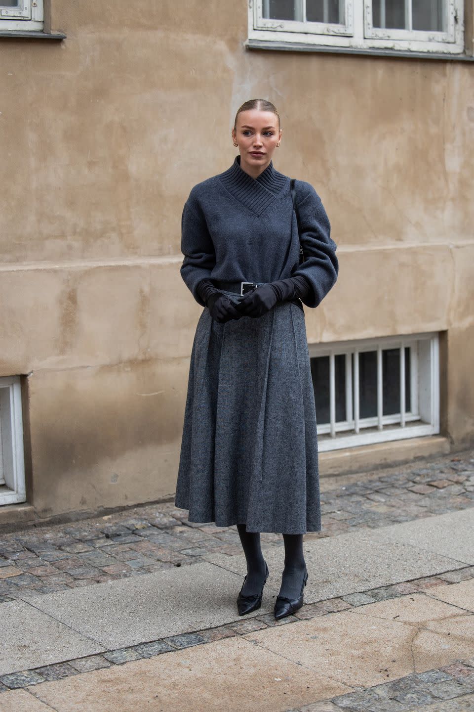 copenhagen, denmark january 30 sophie sunde sylte wears black prada bag, gloves, grey jumper, high waisted skirt, tights, black heels outside lovechild 1979 during the copenhagen fashion week aw24 on january 30, 2024 in copenhagen, denmark photo by christian vieriggetty images