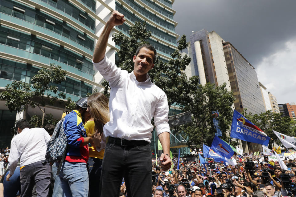 Opposition politician Juan Guaido raises his right fist as he greets supporters at a rally, in Caracas, Venezuela, Saturday, Nov. 16, 2019. Guaido called nationwide demonstrations to re-ignite a campaign against President Nicolas Maduro launched in January that has lost steam in recent months. (AP Photo/Ariana Cubillos)